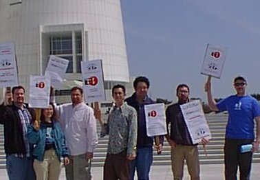 [Pic: group of protestors gathered with picket signs in front of courthouse]